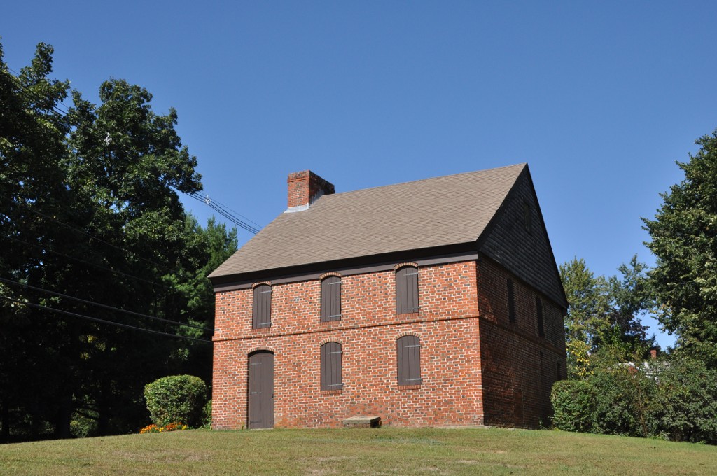 Color photograph of the Dustin House in Haverhill, a restored brick colonial house with white window frames, taken in 2012.